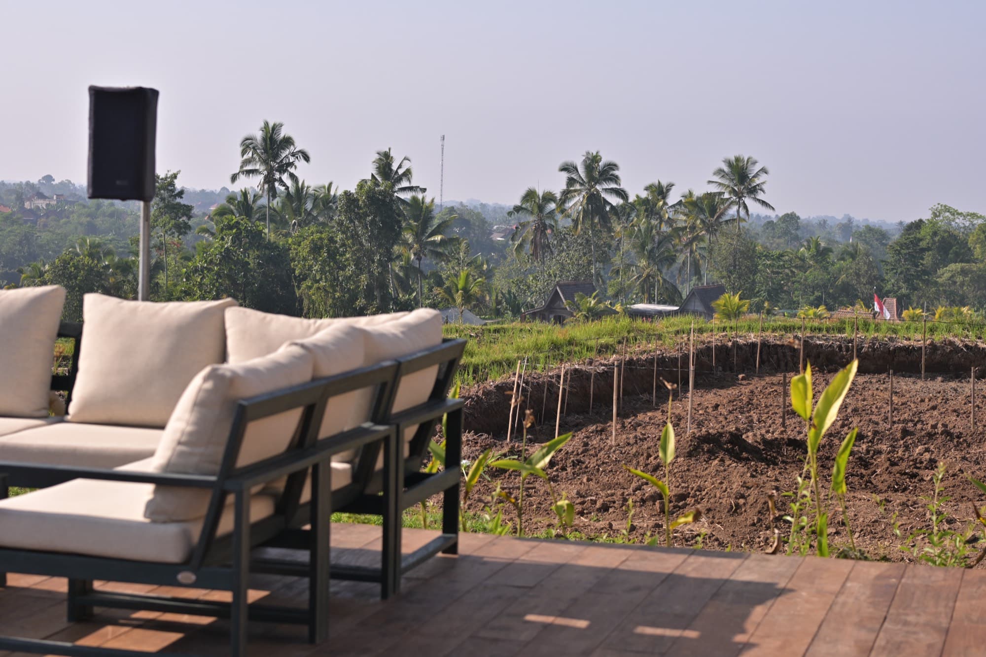 Lounge sofas overlooking the farmland and palms below the retreat