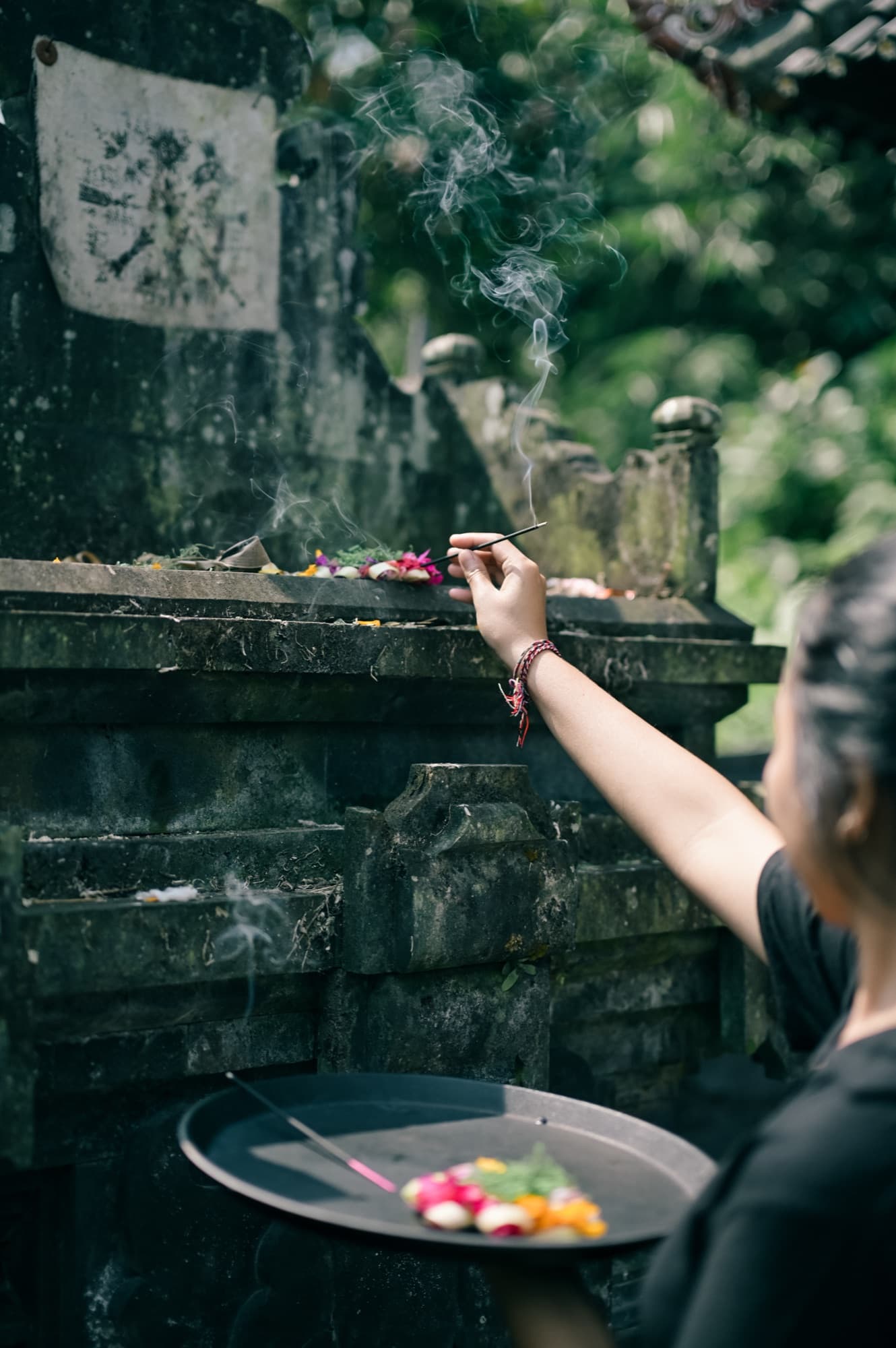 Morning offering of flowers and incense at the temple shrine